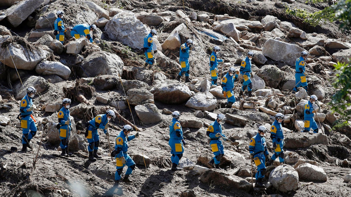 Rescuers search for missing persons at the site of a landslide triggered by Typhoon Hagibis, in Marumori town, Miyagi prefecture, Japan Wednesday, Oct. 16, 2019.