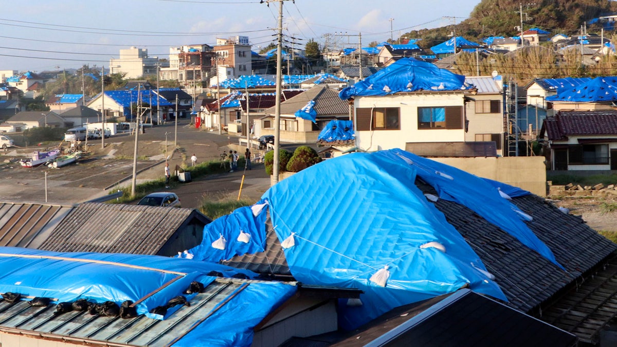 This Oct. 8, 2019, photo shows the sheet-covered roofs of the houses damaged by typhoon Faxai in Tateyama, near Tokyo.
