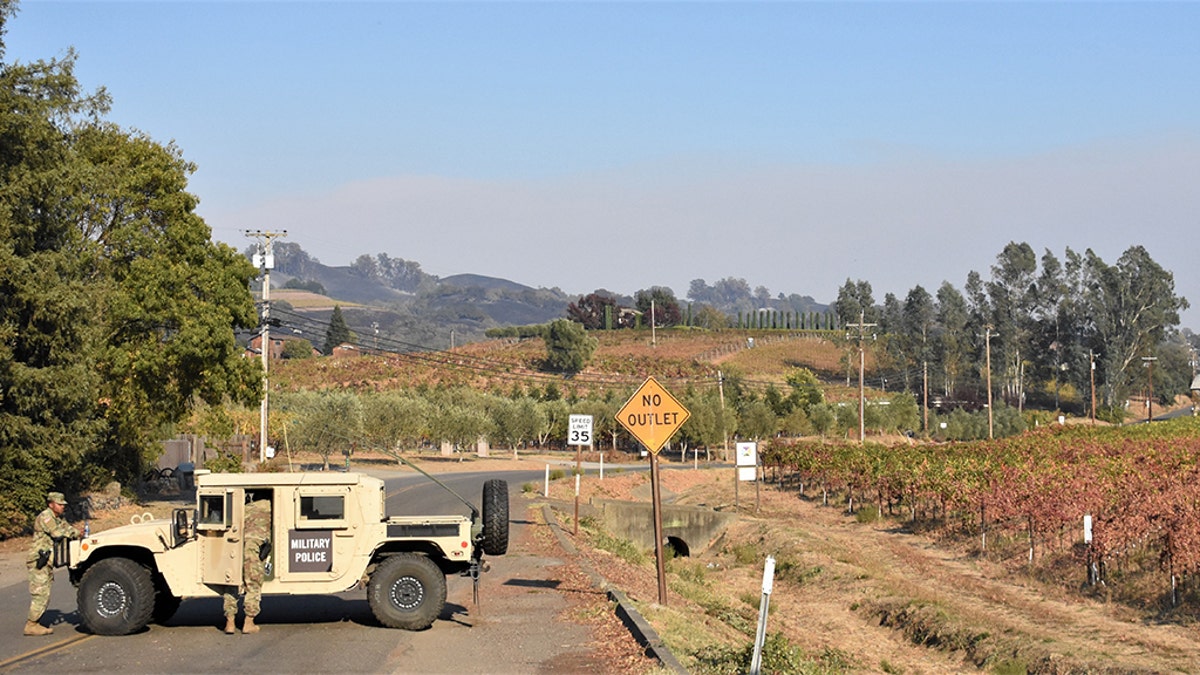 Soldiers from the 49th Military Police Brigade operate a traffic control point along Highway 101 in Healdsburg, assisting local law enforcement with evacuated areas threatened by the Kincade fire. (California National Guard)