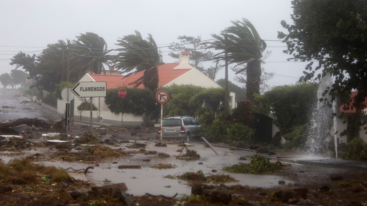Debris blocks a road in the seafront village of Feteira, outside Horta, in the Portuguese island of Faial, Wednesday, Oct. 2, 2019.