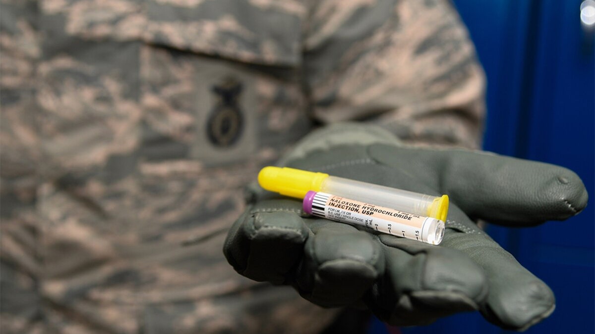 Staff Sergeant Matthew Pick, 66th Security Forces Squadron, holds a nasal applicator and naloxone medication vial, designed to temporarily reverse the effects of an opioid overdose at Hanscom Air Force Base, Mass. Hanscom is the first U.S. Air Force installation to issue the drug to law enforcement personnel under permission of the base commander. (U.S. Air Force photo by Mark Herlihy)