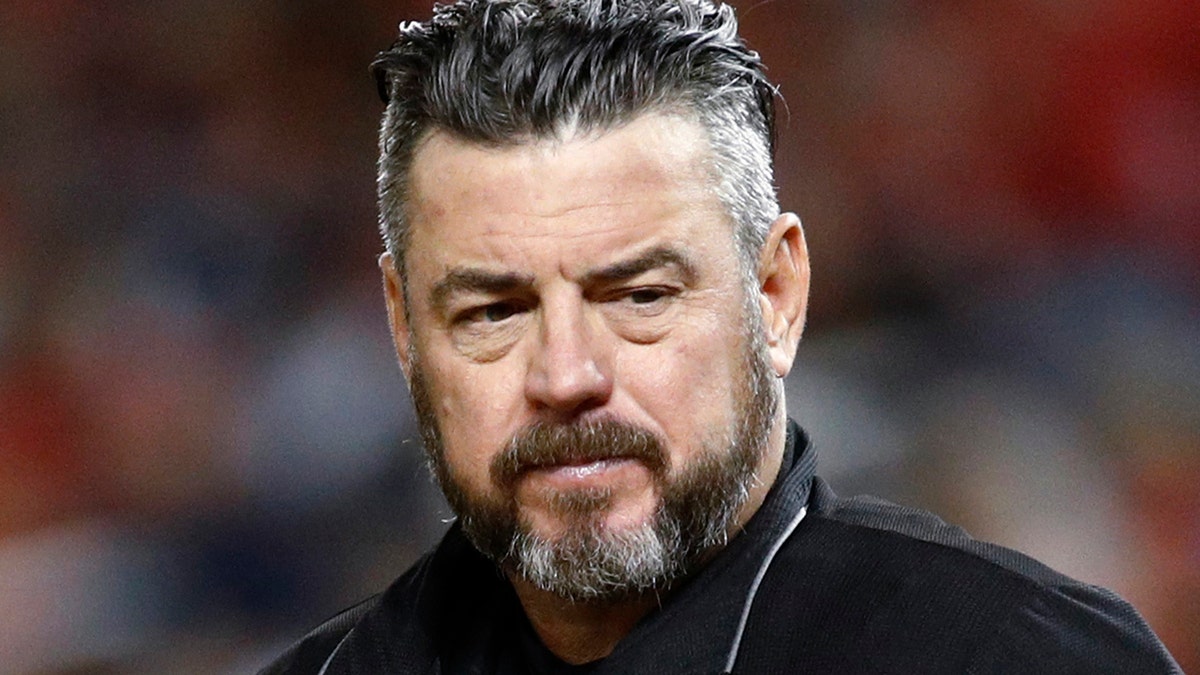 In this Sept. 13, 2019, file photo, umpire Rob Drake stands on the field during a baseball game between the Atlanta Braves and the Washington Nationals in Washington. Commissioner Rob Manfred says Major League Baseball will look into a politicized tweet by Drake that referenced a rifle and criticism of President Donald Trump. 