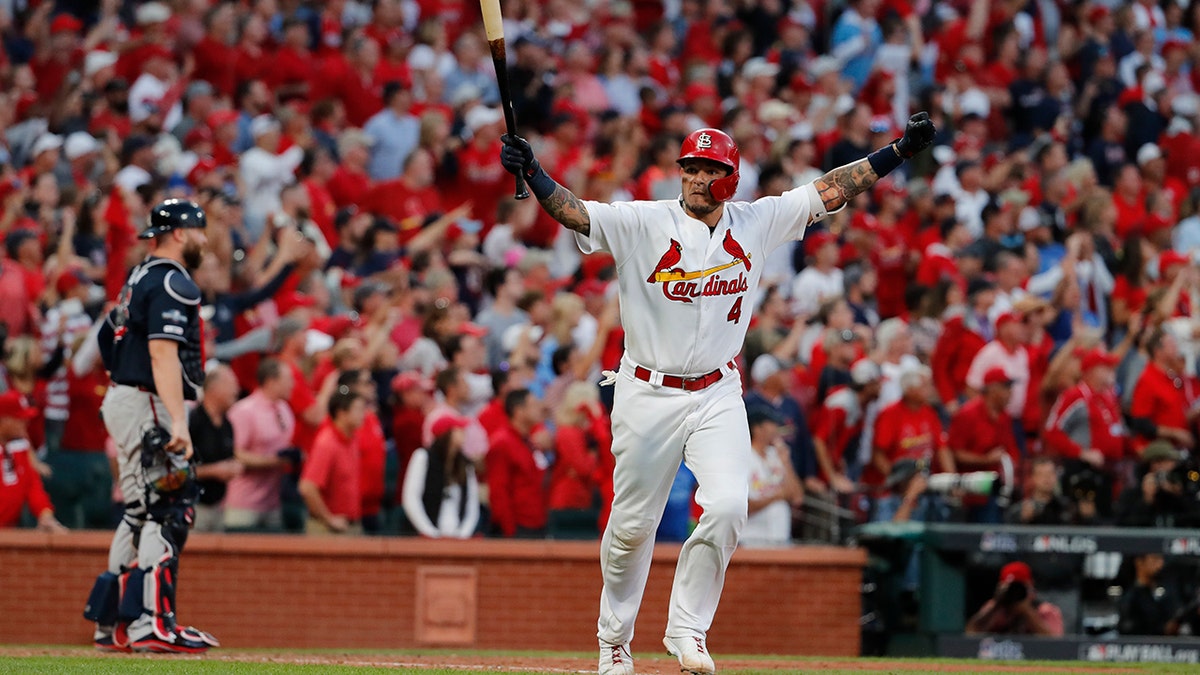 St. Louis Cardinals' Yadier Molina celebrates after hitting a sacrifice fly to score Kolten Wong and defeat the Atlanta Braves in Game 4 of a baseball National League Division Series, Monday, Oct. 7, 2019, in St. Louis. The Cardinals won 5-4. (AP Photo/Jeff Roberson)