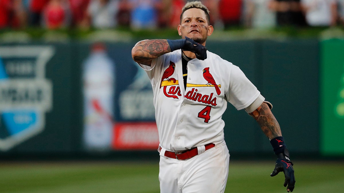 St. Louis Cardinals' Yadier Molina performs throat-slashing