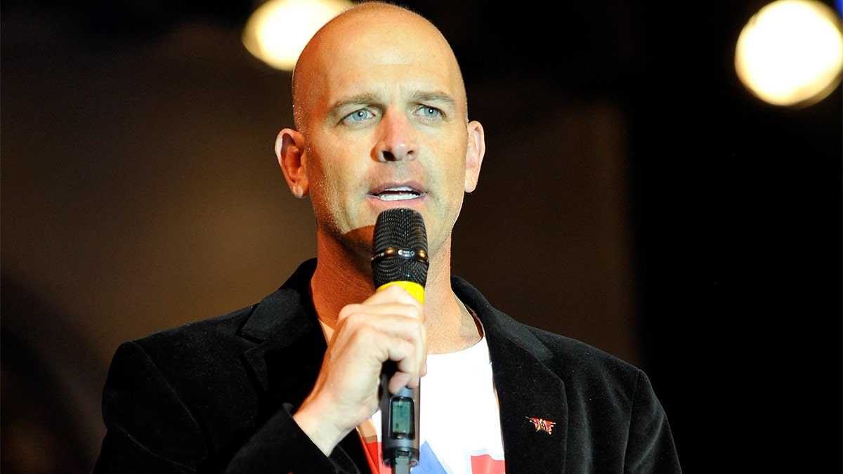 Lt. Col. Dan Rooney speaking onstage at ACM concert Salute To The Military in Las Vegas