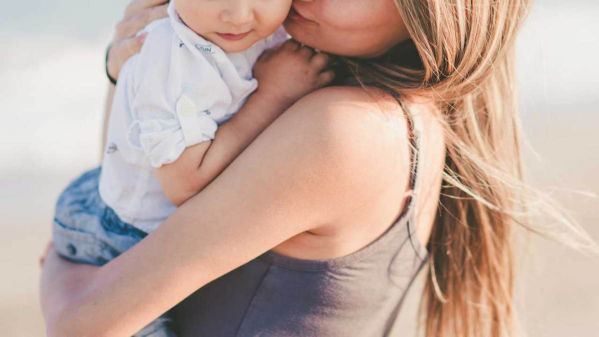 woman hugs child