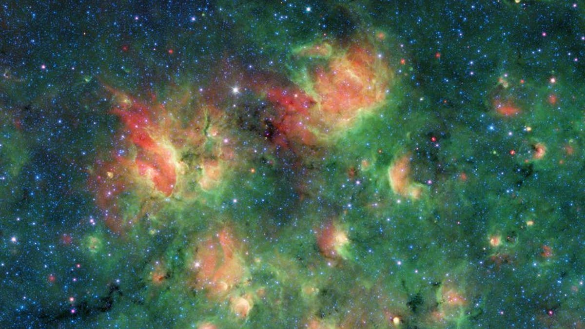 This cloud of gas and dust in space is full of bubbles inflated by wind and radiation from massive young stars. (NASA/JPL-Caltech)