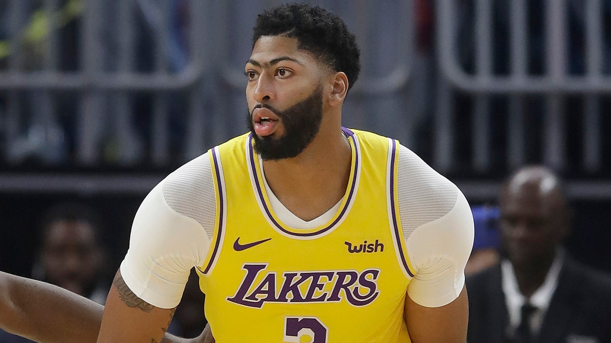 Los Angeles Lakers forward Anthony Davis dribbles during the first half of the team's preseason NBA basketball game against the Golden State Warriors in San Francisco, Saturday, Oct. 5, 2019. (AP Photo/Jeff Chiu)