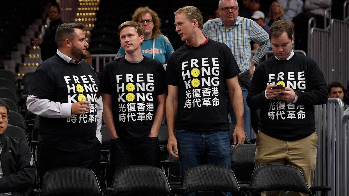 Activists wear "Free Hong Kong" T-shirts before an NBA exhibition basketball game between the Washington Wizards and the Guangzhou Loong-Lions, Wednesday, Oct. 9, 2019, in Washington. (AP Photo/Nick Wass)