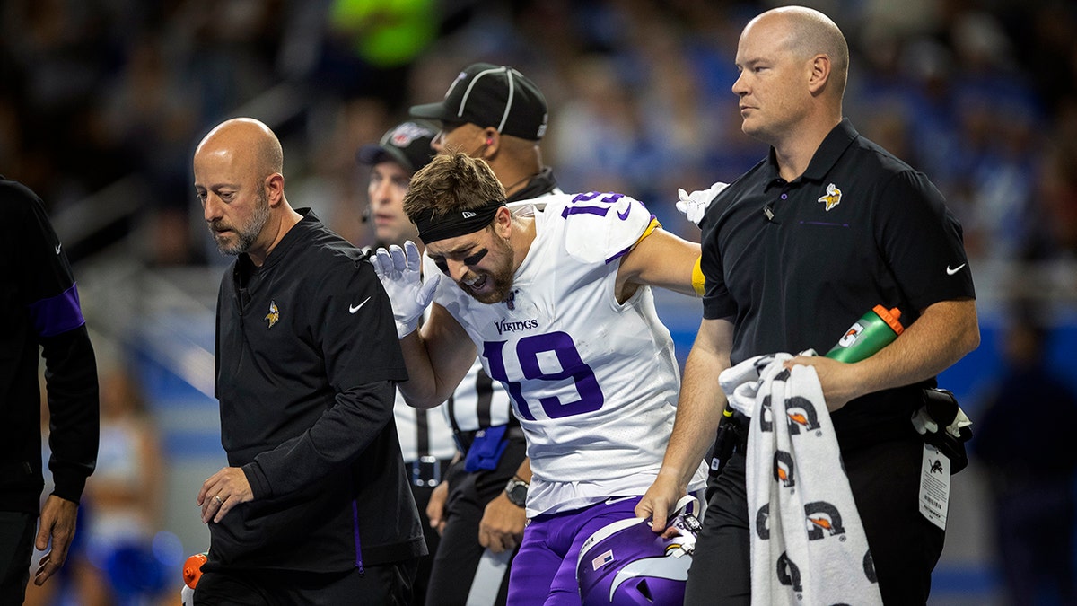 Minnesota Vikings wide receiver Adam Thielen (19) reacts after putting weight on his right leg, as he walks off the field with a hamstring injury in the first quarter of an NFL football game against the Detroit Lions, Sunday, Oct. 20, 2019, in Detroit. (Jerry Holt/Star Tribune via AP)