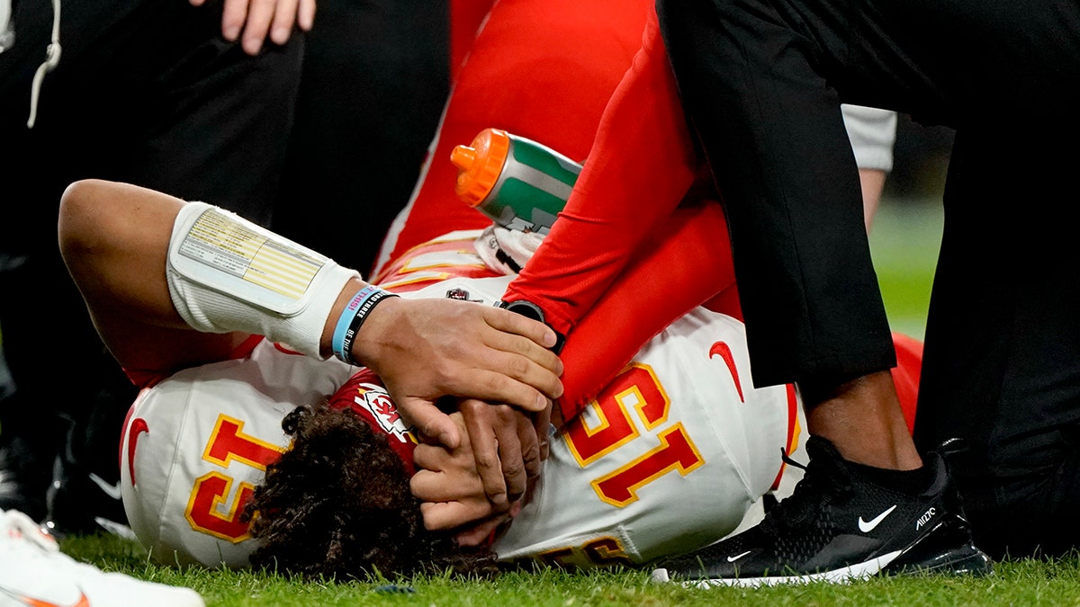 Kansas City Chiefs quarterback Patrick Mahomes (15) is helped by trainers after getting injured against the Denver Broncos during the first half of an NFL football game, Thursday, Oct. 17, 2019, in Denver. (AP Photo/Jack Dempsey)