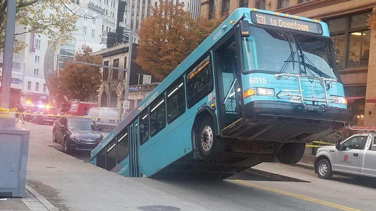 A bus was swallowed in a sinkhole in downtown Pittsburgh on Monday.
