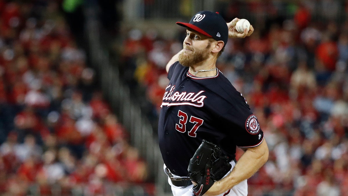 Washington Nationals starting pitcher Stephen Strasburg throws during the first inning of Game 3 of the baseball National League Championship Series against the St. Louis Cardinals Monday, Oct. 14, 2019, in Washington. (AP Photo/Jeff Roberson)