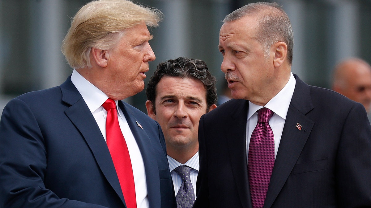 FILE 2018: President Donald Trump, left, talks with Turkey's President Recep Tayyip Erdogan, as they arrive together for a family photo at a summit of heads of state and government at NATO headquarters in Brussels. (AP Photo/Pablo Martinez Monsivais, File)