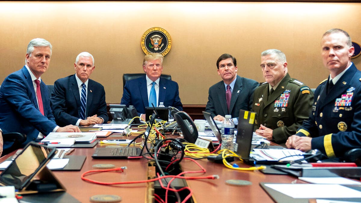 In this photo provided by the White House, President Donald Trump is joined by from left, national security adviser Robert O'Brien, Vice President Mike Pence, Defense Secretary mark Esper, Joint Chiefs Chairman Gen. Mark Milley and Brig. Gen. Marcus Evans, Deputy Director for Special Operations on the Joint Staff, Saturday, Oct. 26, 2019, in the Situation Room of the White House. (Shealah Craighead/The White House via AP)