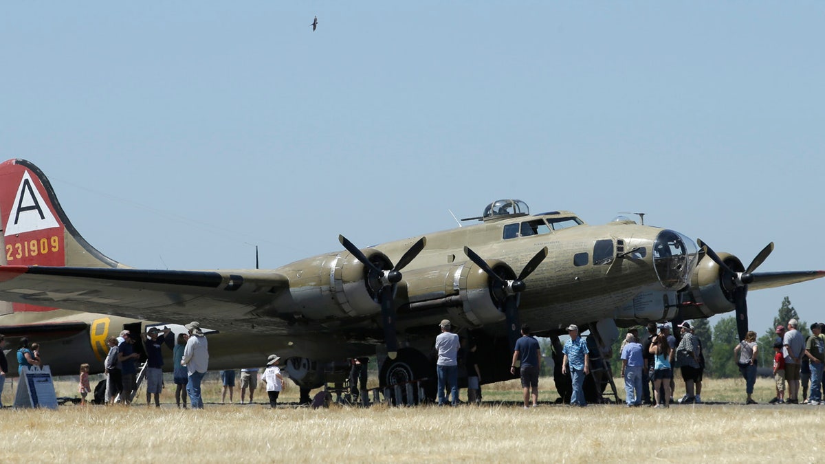 In this photo taken June 2, 2018 photo, people line up to tour the Nine-O-Nine, a Collings Foundation B-17 Flying Fortress, at McClellan Airport in Sacramento, Calif.