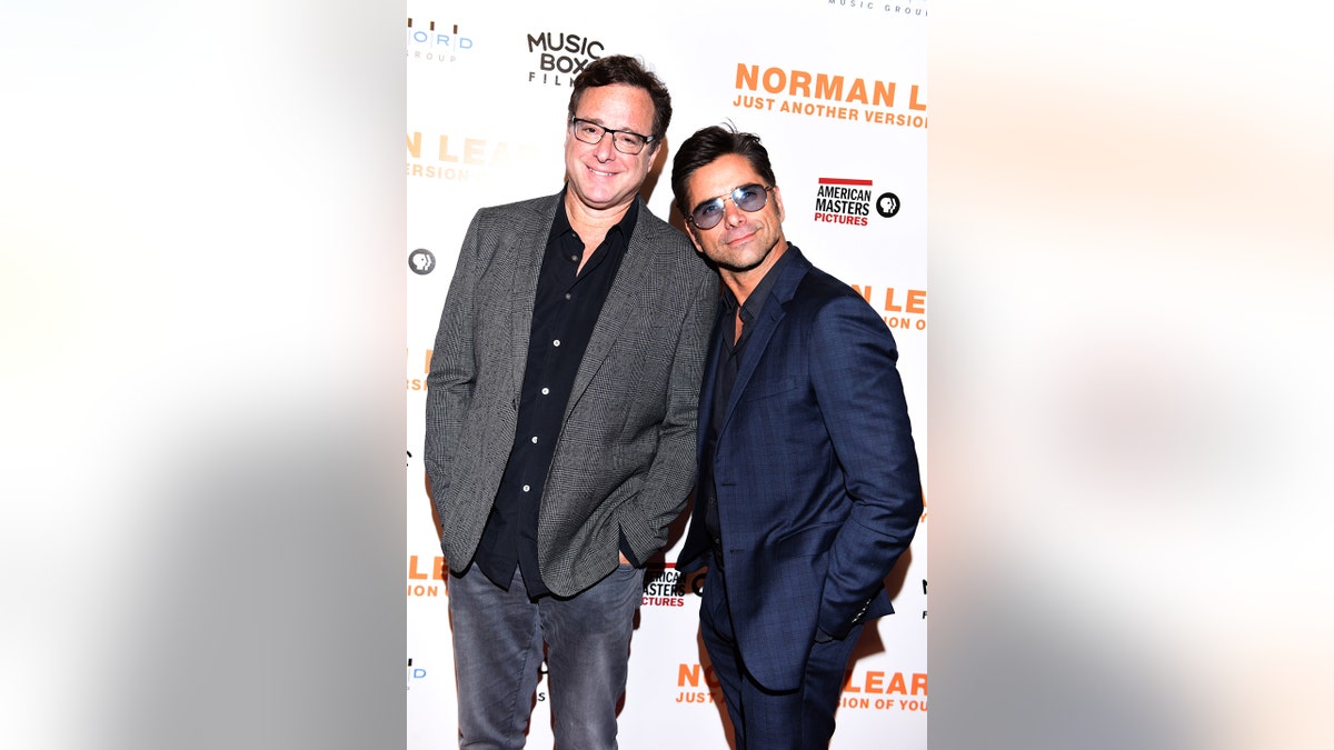 Actors Bob Saget and John Stamos attend the Los Angeles Premiere of "NORMAN LEAR: JUST ANOTHER VERSION OF YOU" on July 14, 2016, in Los Angeles, California.