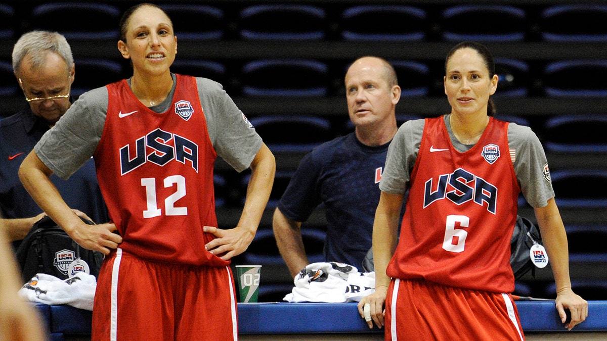 FILE - In this July 14, 2012, file photo, U.S women's Olympic basketball players Diana Taurasi (12) and Sue Bird (6) watch during practice in Washington. The U.S. women’s national basketball team college tour is set to tip off next month. USA Basketball announced Wendesday, Oct. 9, 2019, that members of the national team will play exhibition games at Stanford, Oregon State, Texas A&amp;M and Oregon in early November to prepare for the upcoming FIBA tournament later next month. (AP Photo/Nick Wass, File)