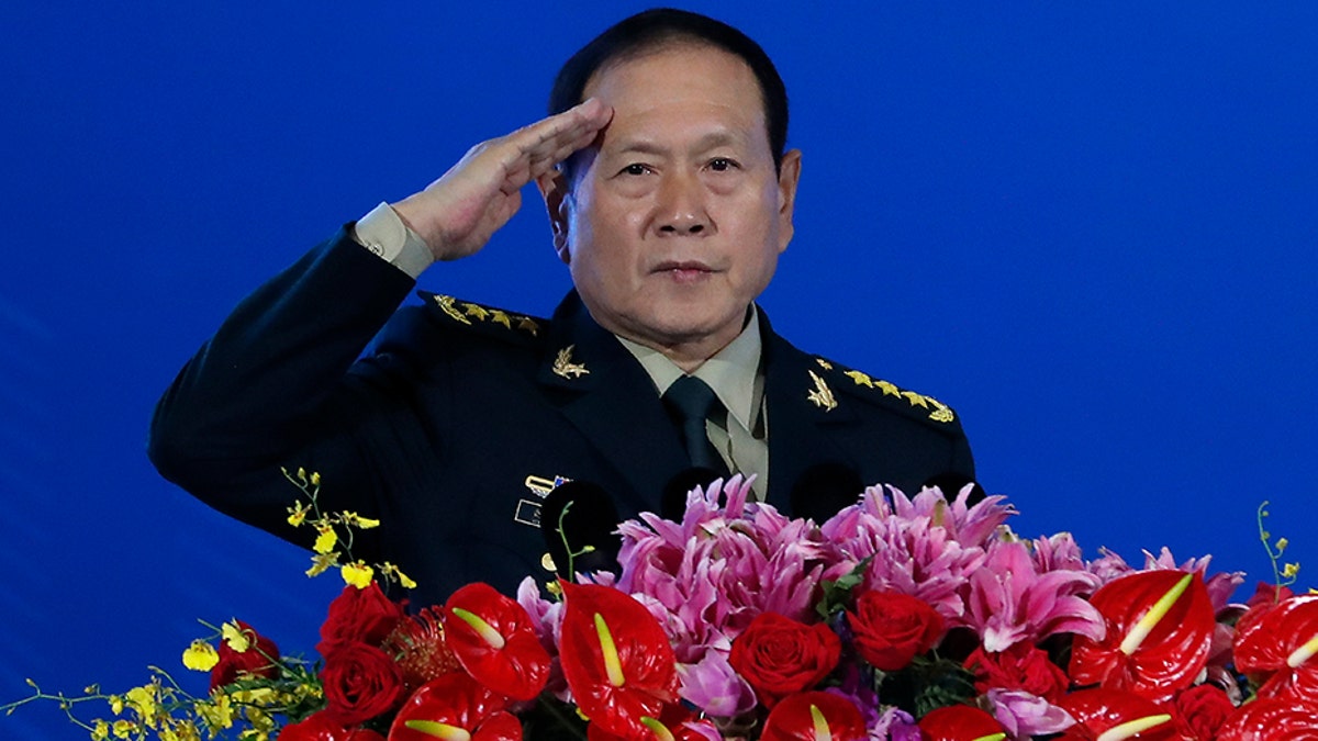 Chinese Defense Minister Wei Fenghe salutes after delivering his opening speech for the Xiangshan Forum, a gathering of the region's security officials, in Beijing, on Monday. Wei issued a stinging rebuke of the U.S. at a defense forum in Beijing, saying China wasn't fazed by sanctions, pressure and a "big stick policy." (AP)