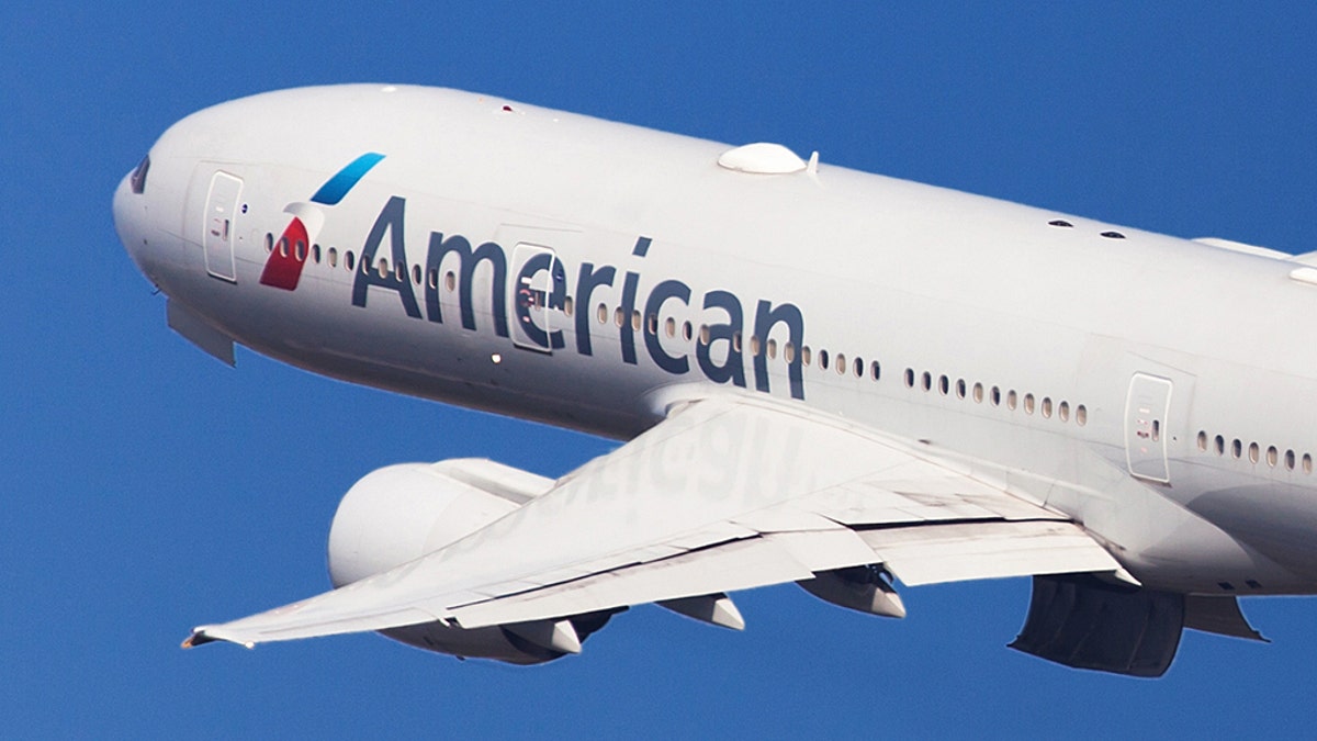 Barcelona, Spain - August 21, 2018: American Airlines Boeing 777-200ER banking left after taking off from El Prat Airport in Barcelona, Spain.