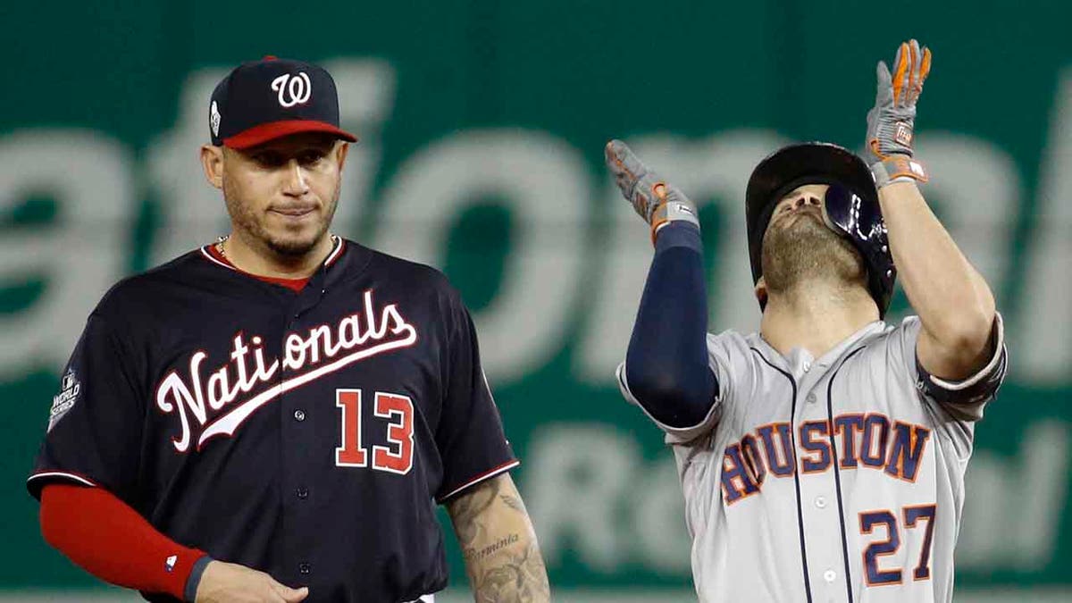 Houston Astros' Jose Altuve, right, celebrates next to Washington Nationals second baseman Asdrubal Cabrera after a double during the fifth inning of Game 3 of the baseball World Series Friday, Oct. 25, 2019, in Washington. (Associated Press)