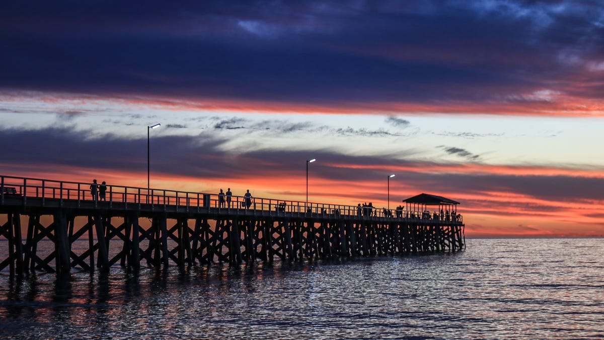 A dramatic sky with stunning colours during sunset over Grange beach in Adelaide (Amer Ghazzal/Barcroft Media via Getty Images)