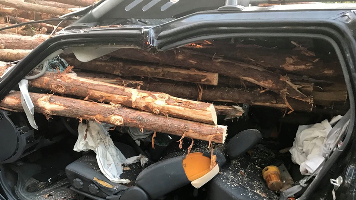 The logs came precariously close to the driver in the SUV.
