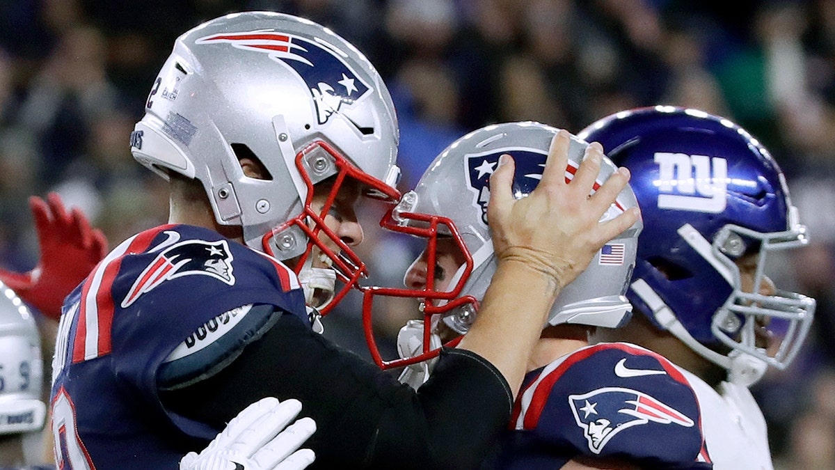 New England Patriots quarterback Tom Brady, left, celebrates his touchdown with Gunner Olszewski after scoring on a quarterback sneak in the second half of an NFL football game against the New York Giants, Thursday, Oct. 10, 2019, in Foxborough, Mass. (Associated Press)