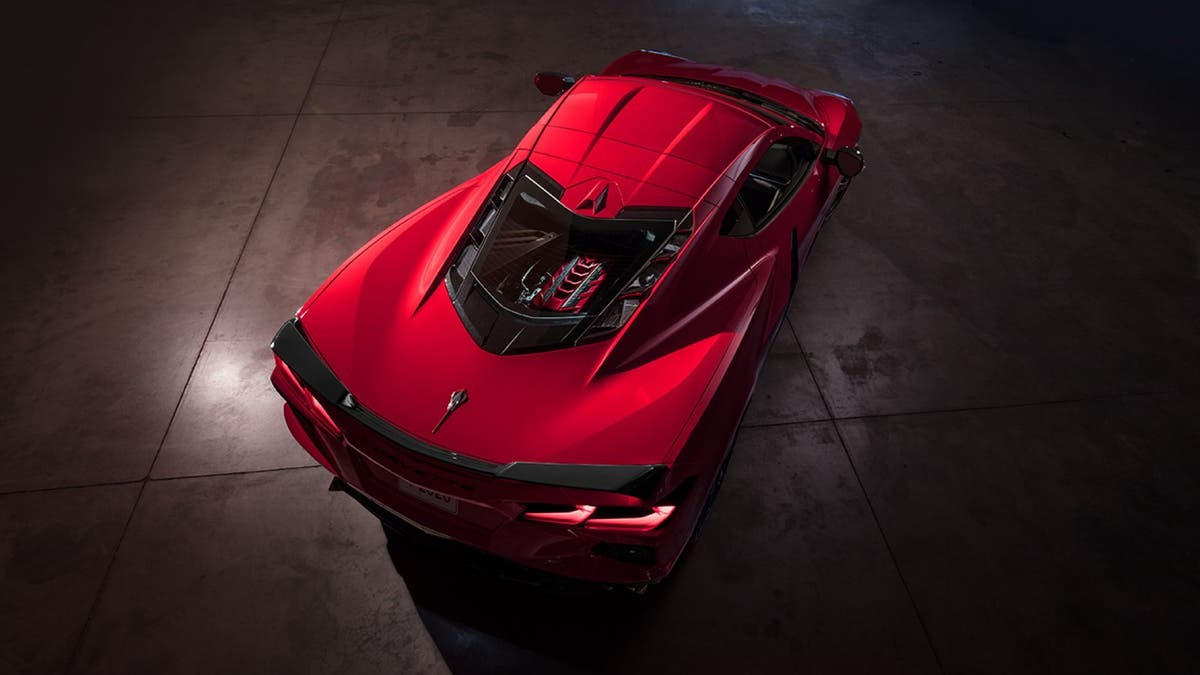 The Stingray coupe features a transparent engine cover in place of the convertible's tonneau.