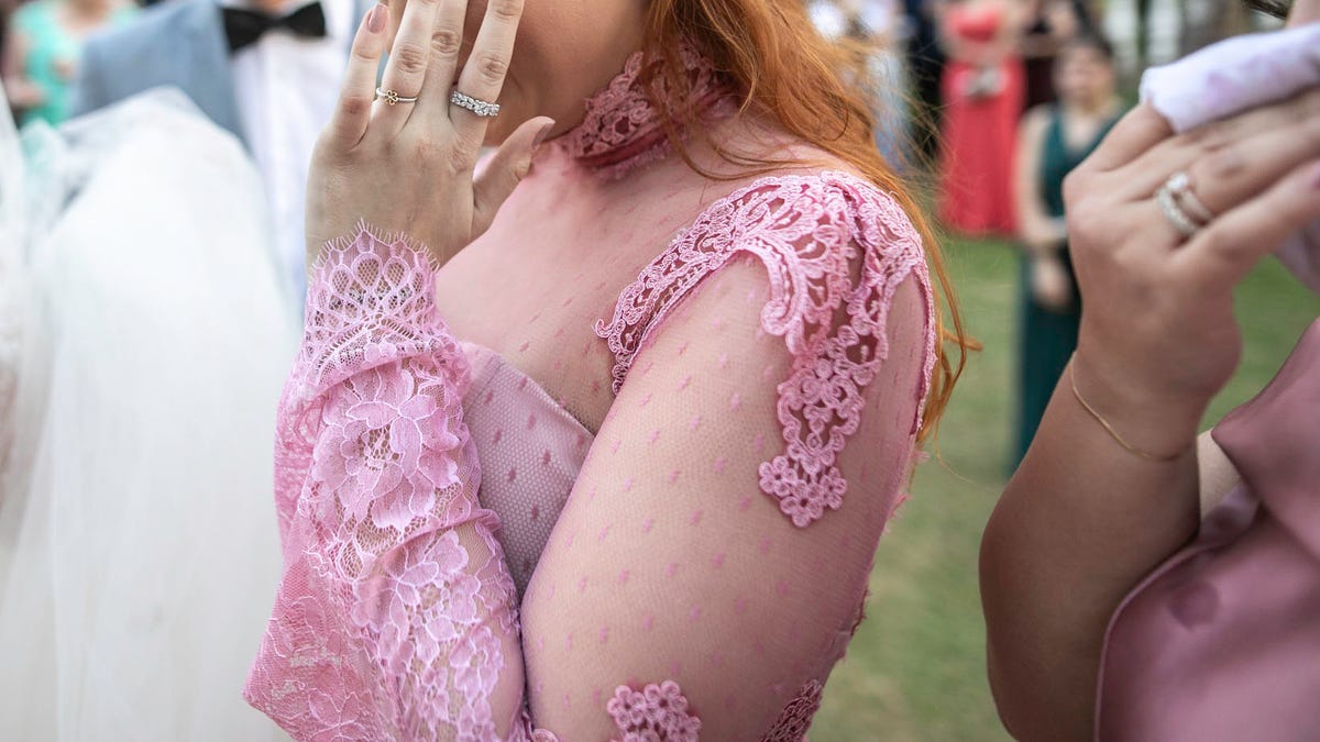 Side view of a bridesmaid crying during wedding ceremony