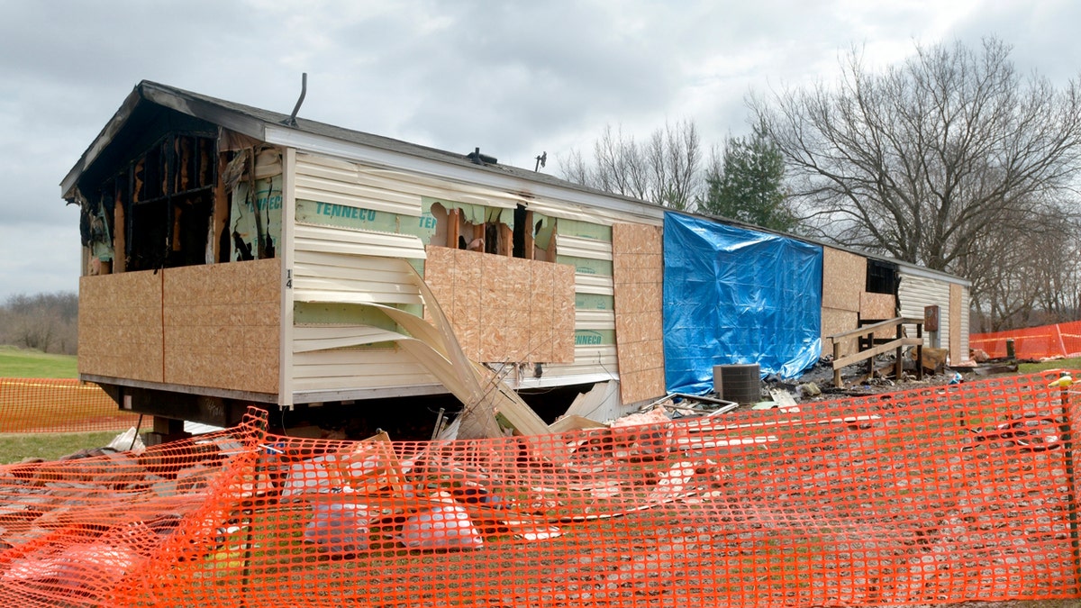 This photo taken April 7, 2019, shows a fence and caution tape surrounding a trailer home that was destroyed by fire in the Timberline Mobile Home Park northeast of Goodfield. (Matt Dayhoff/Journal Star via AP)