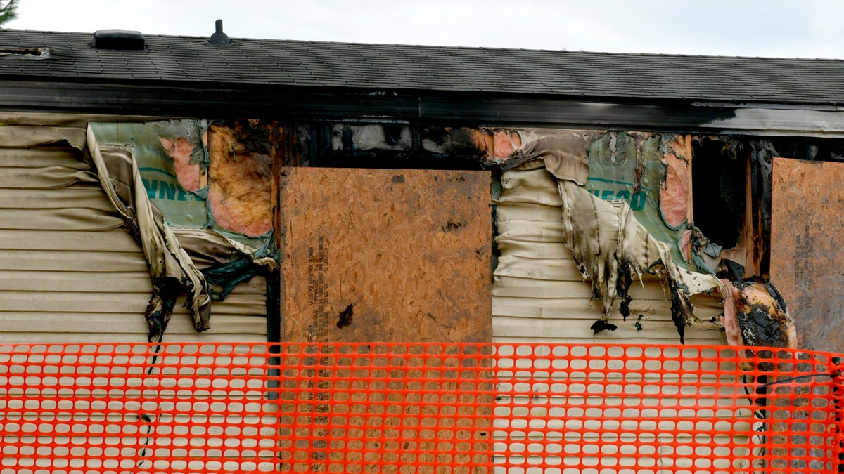 This photo taken April 7, 2019, shows melted vinyl siding hanging off the side of a trailer home at 14 Cypress Court in the Timberline Mobile Home Park northeast of Goodfield. (Matt Dayhoff/Journal Star via AP)