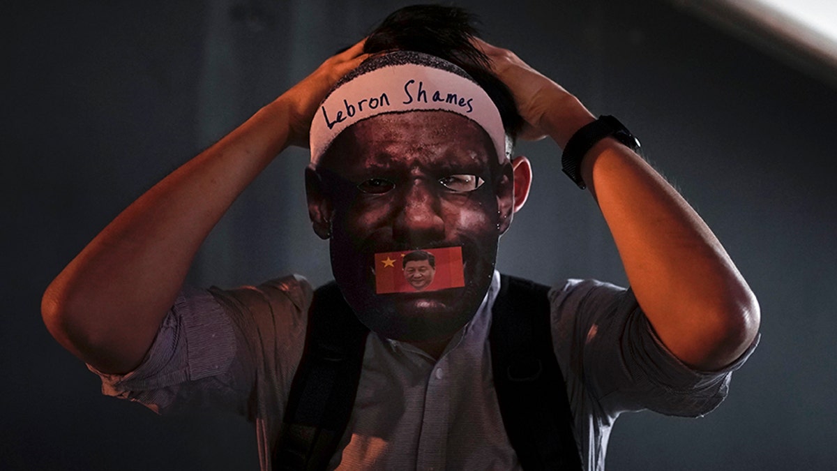 A protester wears a mask of LeBron James during a demonstration in Hong Kong on Friday. (AP)