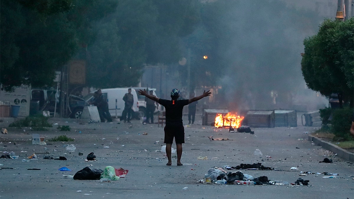 A protester stands in the street during a demonstration in Baghdad, Iraq on Tuesday. (AP Photo/Hadi Mizban)