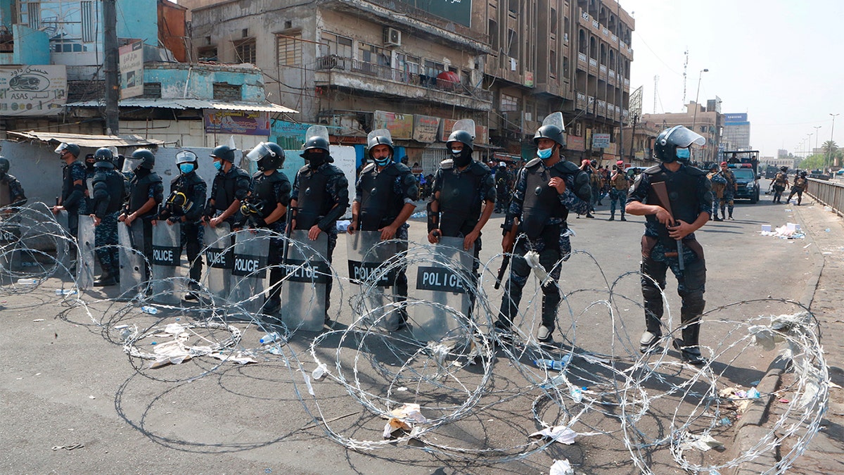 Iraqi security forces close streets to prevent anti-government protesters from reaching Tahrir Square in central Baghdad,on Wednesday. (AP Photo/Khalid Mohammed)