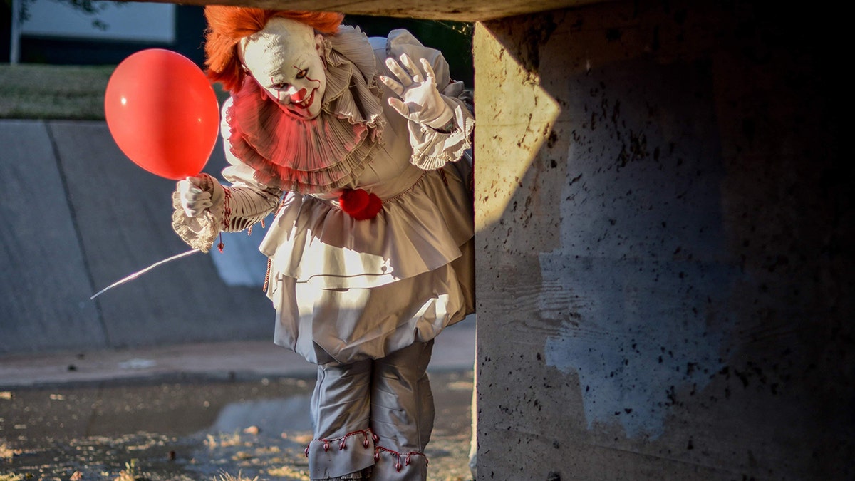 Maci Ann Tate dressed up as the clown Pennywise from the movie, while her boyfriend Jonathan dressed up as character Georgie.