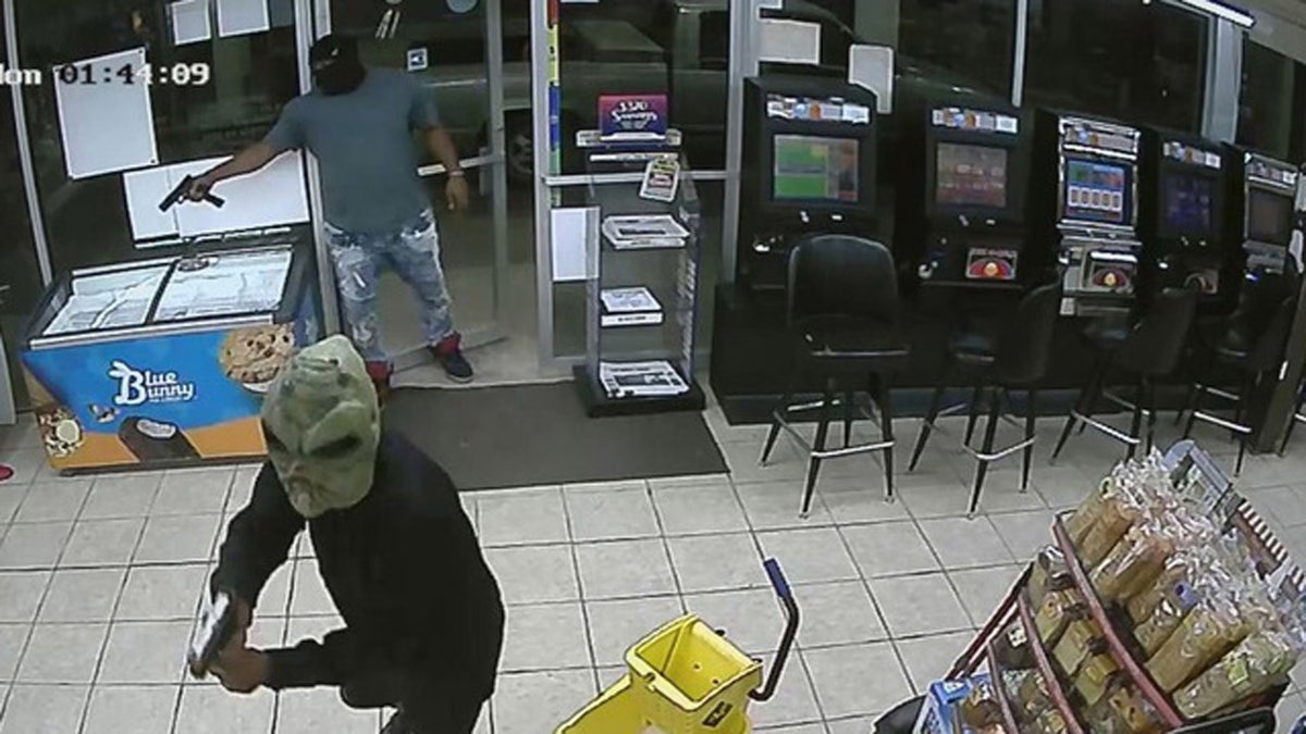 Two suspects, including one wearing an alien mask, were involved in the fatal shooting of a gas station clerk on Monday, according to Houston police.