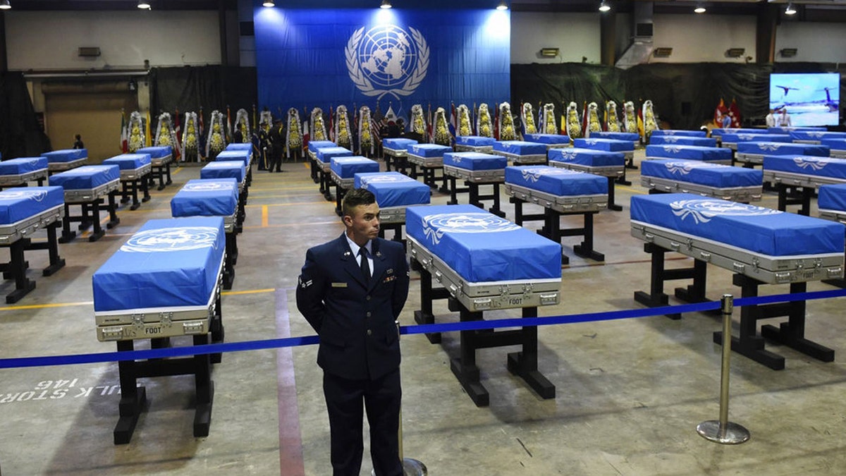 A U.S. airman stands guard next to caskets containing remains of U.S. soldiers killed in the Korean War and collected in North Korea before a repatriation ceremony at Osan Air Base in Pyeongtaek, South Korea, in August 2018.