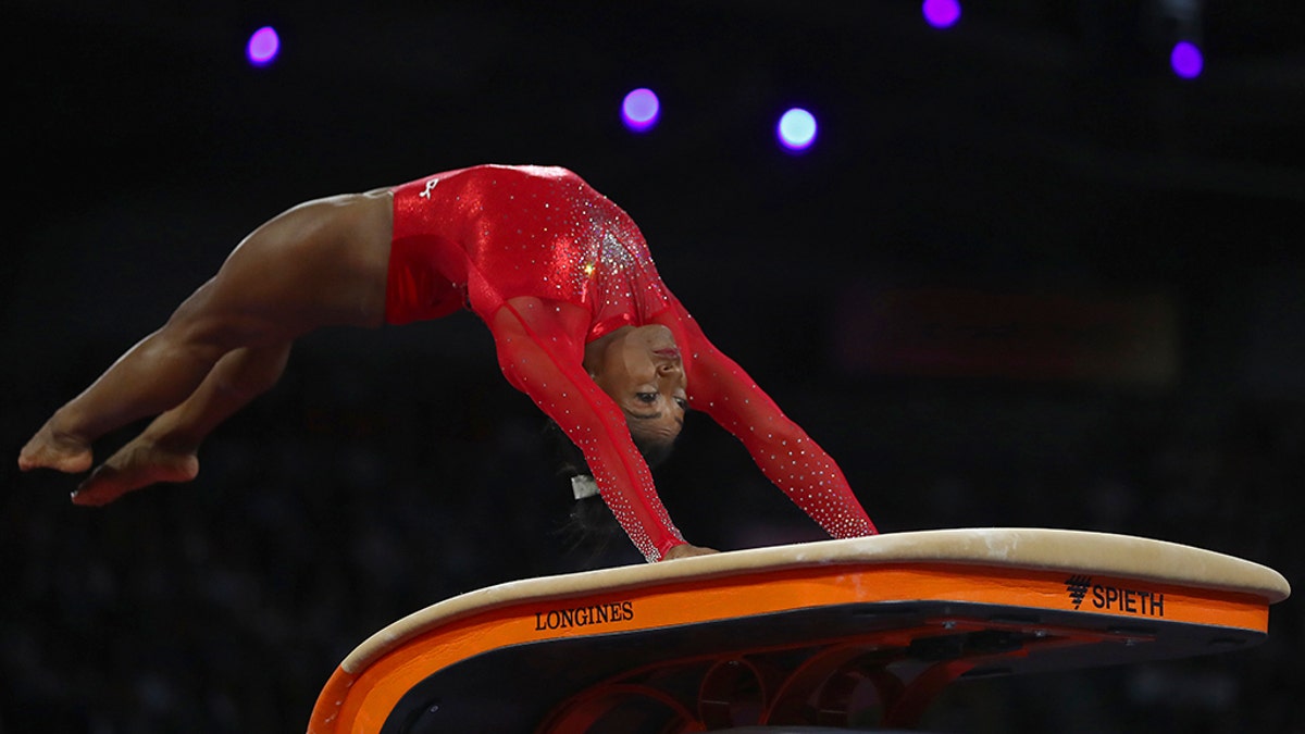 Gold medalist Simone Biles of the United States performs on the vault in the women's apparatus finals at the Gymnastics World Championships in Stuttgart, Germany, Saturday, Oct. 12, 2019. (AP Photo/Matthias Schrader)