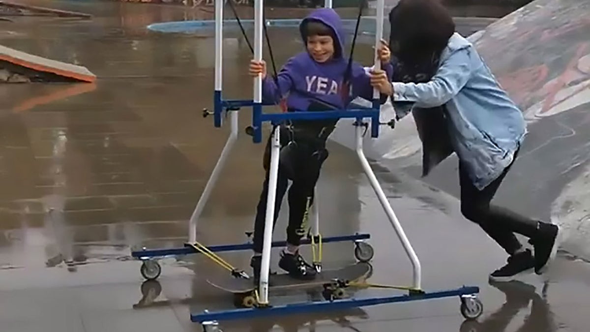 His mom helped push him around the park and up and down the ramps.