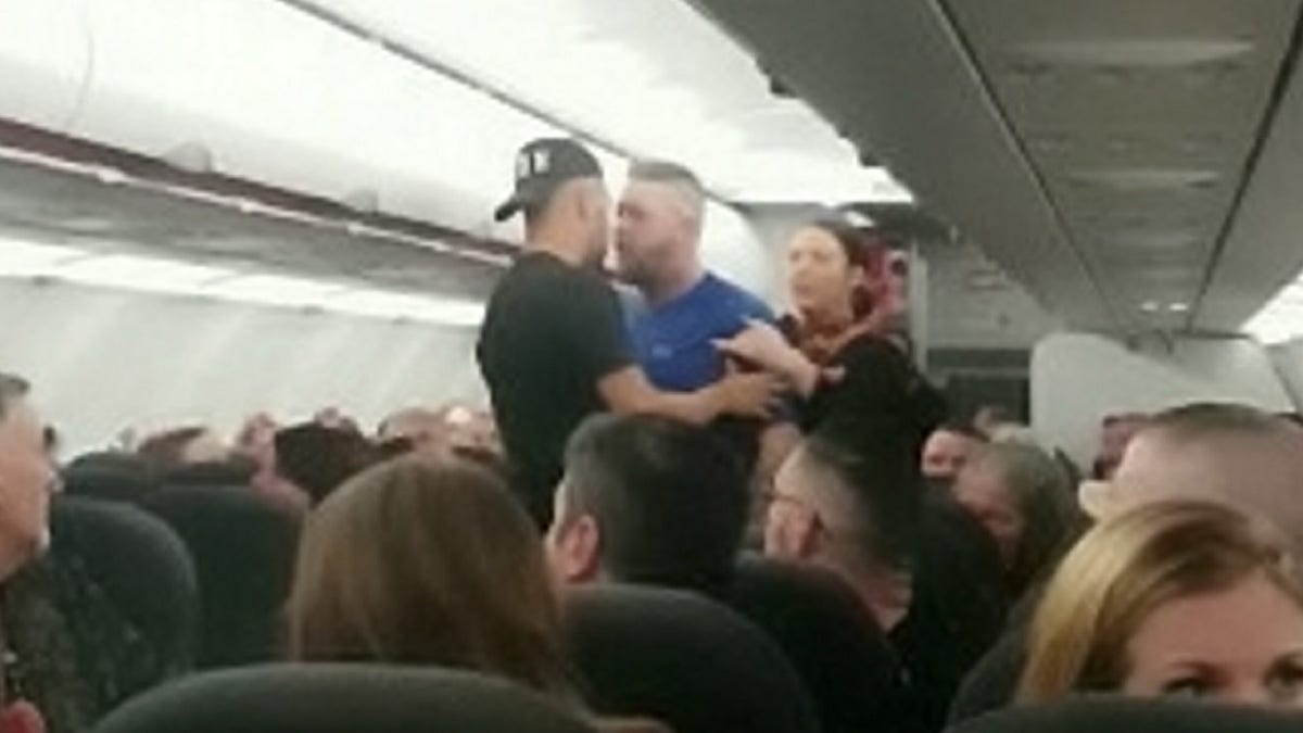 The fight originally broke out at the rear of the plane before the men were separated. A witness says they resumed fighting after a little while, prompting the pilot to make an unscheduled stop in Portugal.