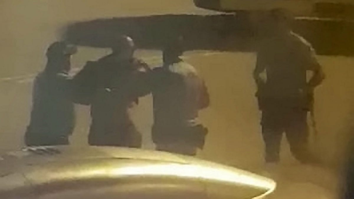 A total of 7 men were escorted from the plane. Footage from inside the cabin shows security struggling with one of the men before leading him away in handcuffs.