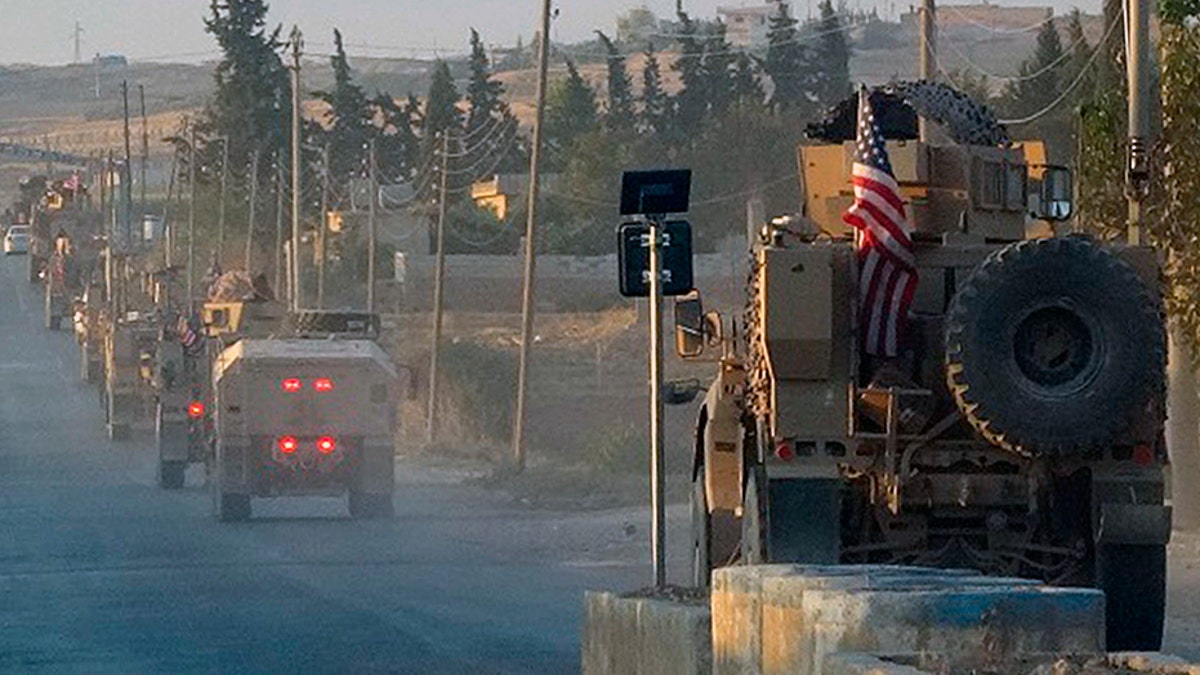 In this image from Hawar News Agency, U.S. military vehicles travel down a main road in northeast Syria on Monday.