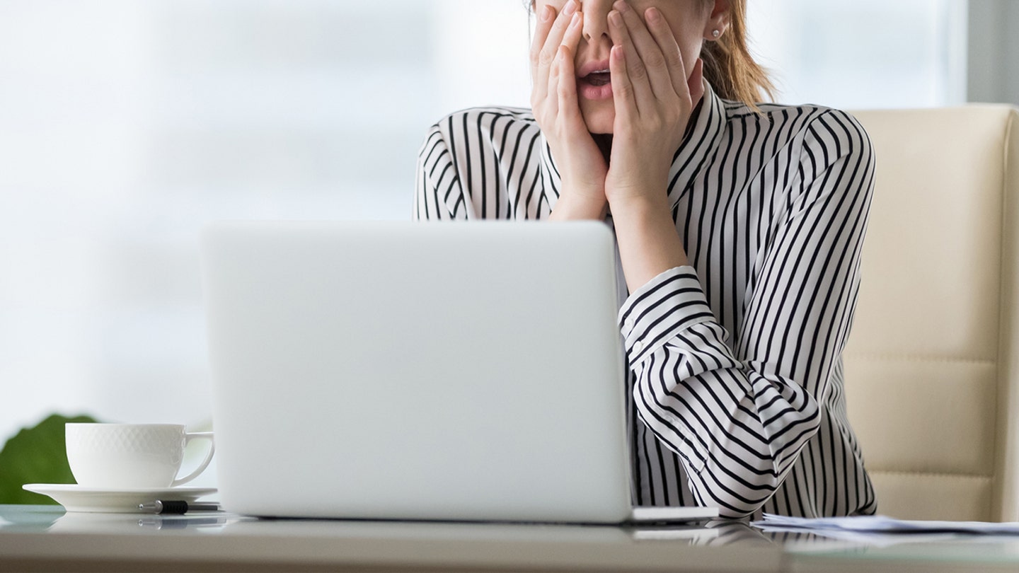 woman computer shocked istock