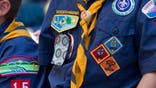 FILE- In this June 25, 2016, file photo, Cub Scouts watch a race during the Second Annual World Championship Pinewood Derby in New York's Times Square. In January 2020, the Boy Scouts of America will increase its annual youth membership fee by more than 80% as it faces a potentially ruinous wave of new sex-abuse lawsuits. (AP Photo/Mary Altaffer, File)