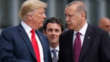 President Donald Trump, left, talks with Turkey's President Recep Tayyip Erdogan, as they arrive together for a family photo at a summit of heads of state and government at NATO headquarters in Brussels. The White House says Turkey will soon invade Northern Syria, casting uncertainty on the fate of the Kurdish fighters allied with the U.S. against in a campaign against the Islamic State group. (AP Photo/Pablo Martinez Monsivais, File)