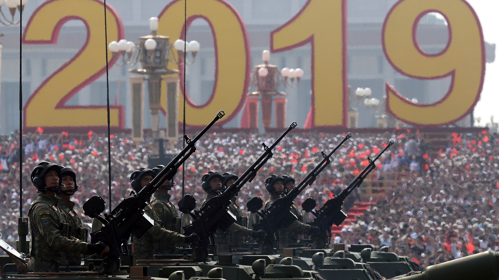 Army vehicles roll down the street during a parade to commemorate the 70th anniversary of the founding of Communist China in Beijing, Oct. 1, 2019. 