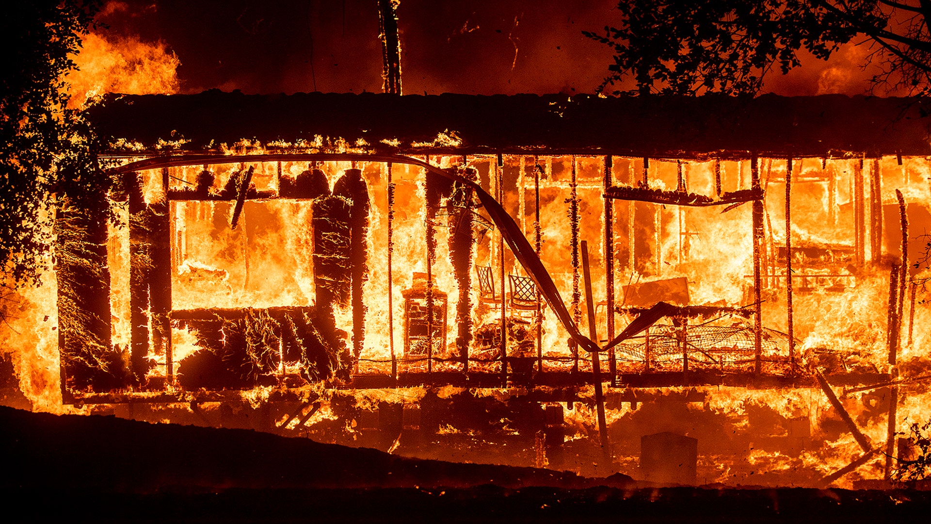 Flames consume a home as the Kincade Fire tears through the Jimtown community of Sonoma County, California, Oct. 24, 2019. 
