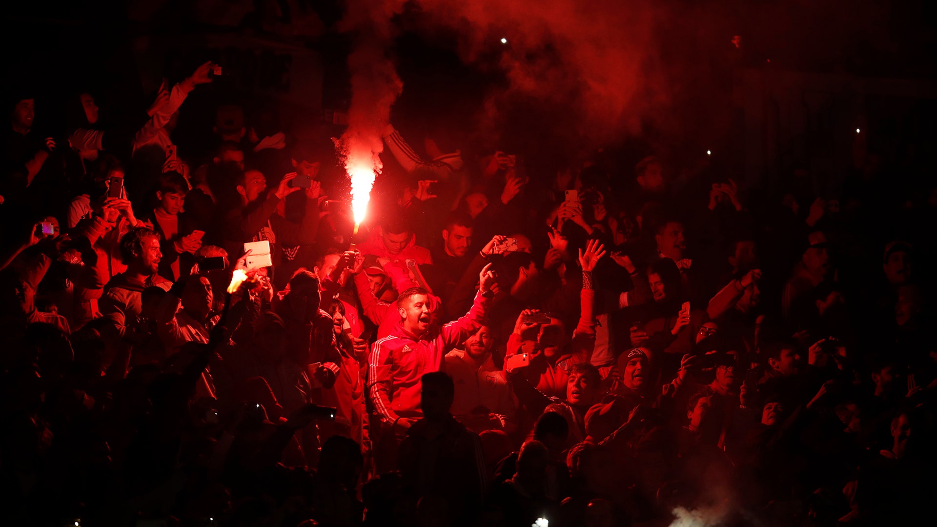 Fans of Argentina's River Plate light flares prior to a semifinal first leg Copa Libertadores soccer match against Argentina's Boca Juniors in Buenos Aires, Argentina, Oct. 1, 2019. 