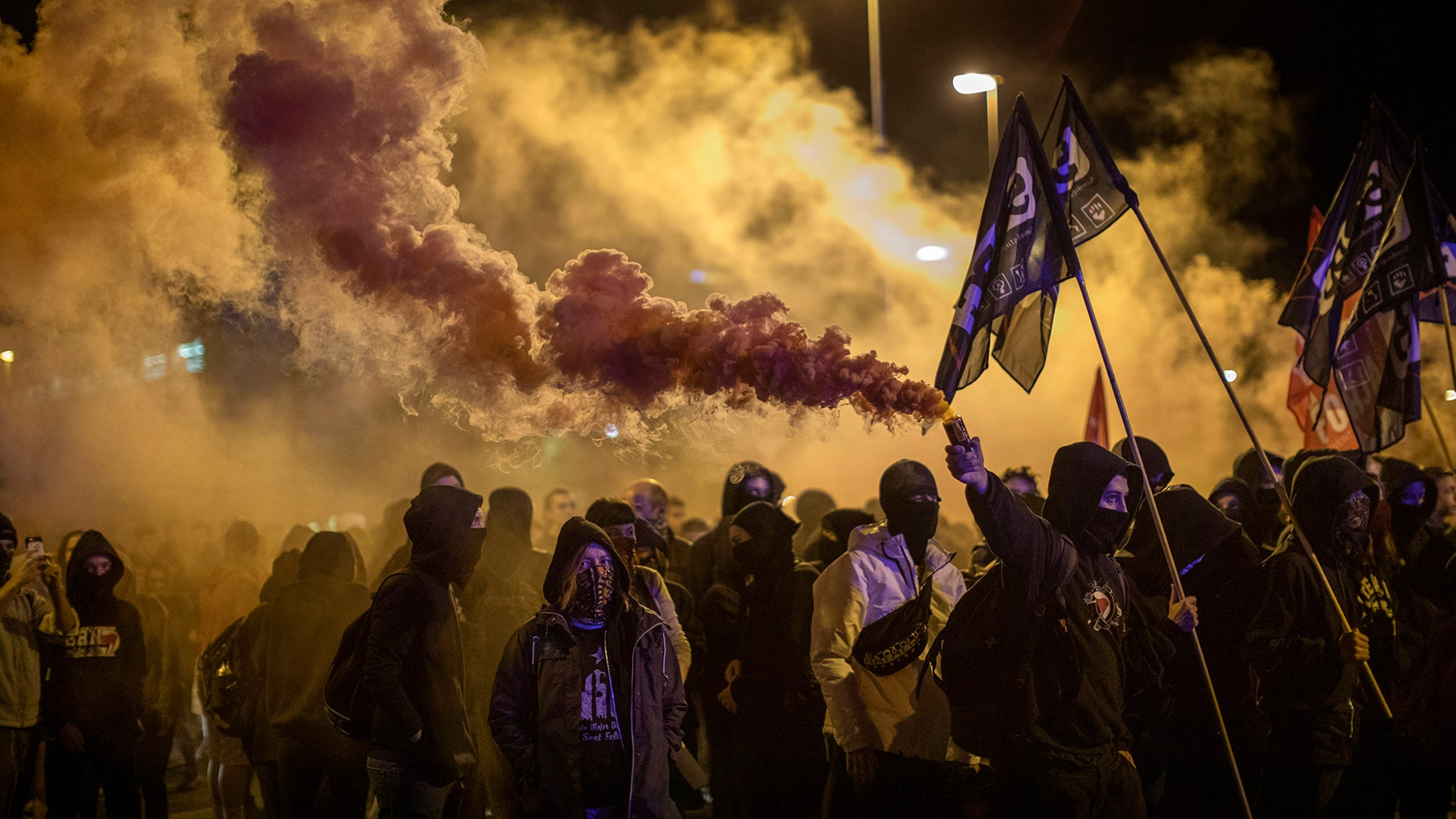 Pro-independence demonstrators, some of them holding flares, march as they take part in a demonstration in Girona, Spain, Oct. 1, 2019. 
